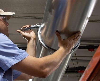 Worker installing Nordfab Quick-Fit Ducting.