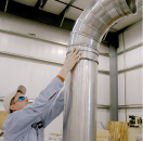Technicians installating Nordfab ductwork in a facility.