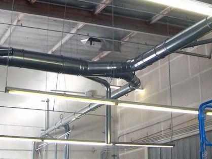 Dust collector ductwork shown installed in an industrial building.