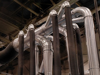 Galvanized steel ductwork installed in an industrial facility.