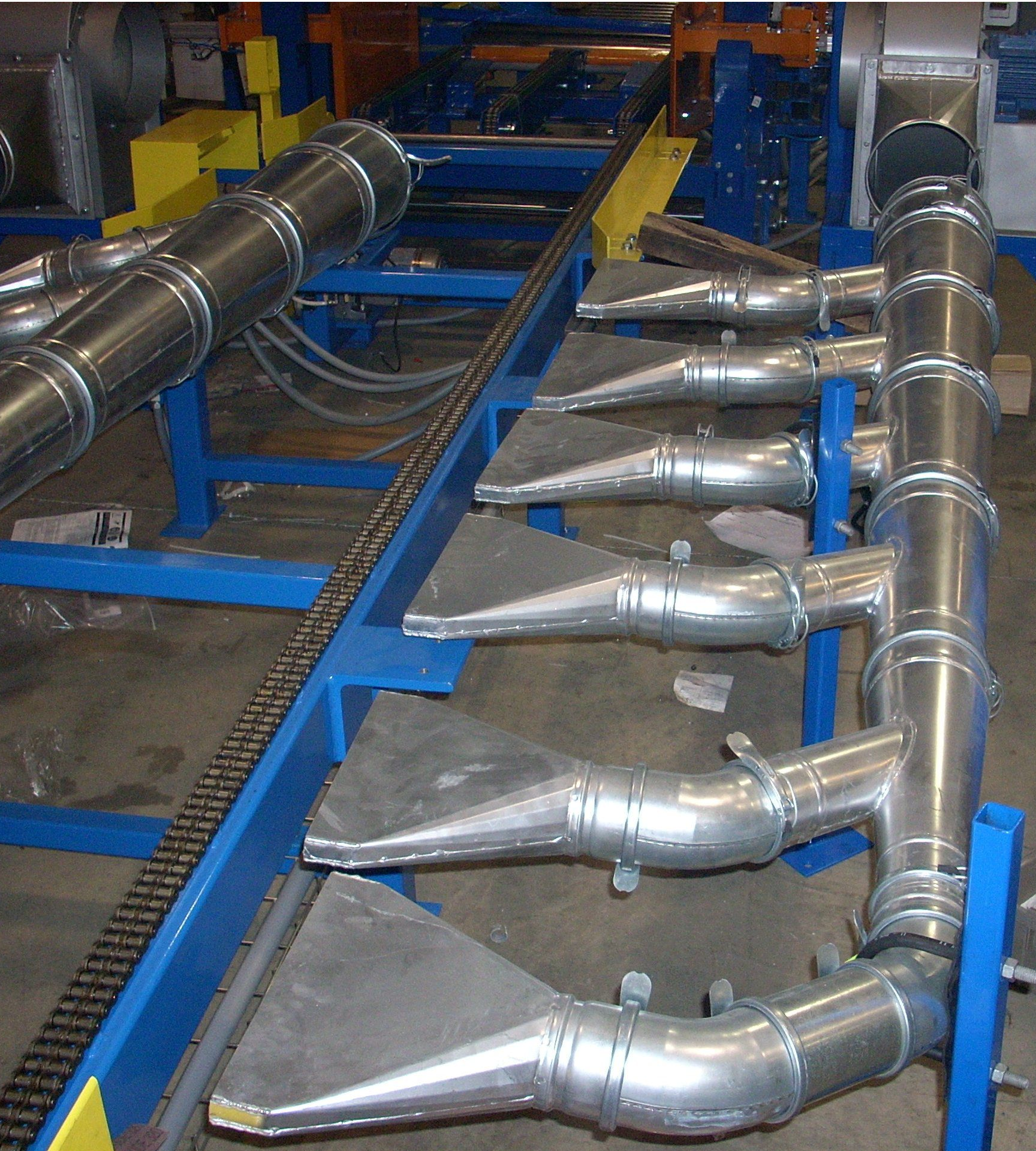 Galvanized ductwork system installed in an industrial facility.