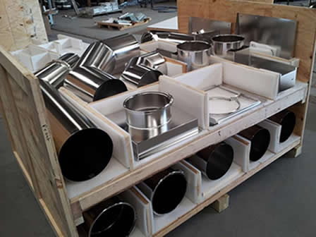 Inventory of stainless steel ducting parts by Nordfab in a warehouse.